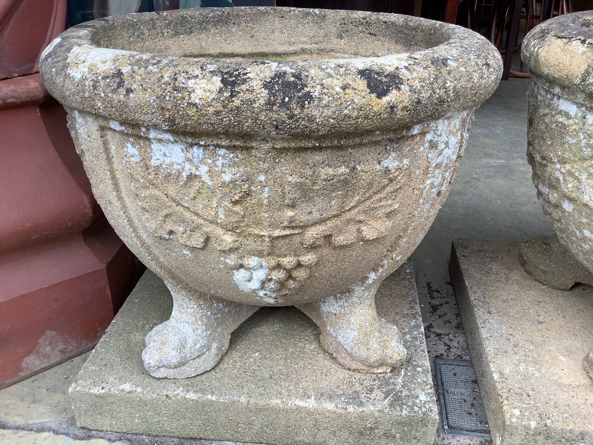 A pair of 19th century circular reconstituted stone garden planters on square plinth bases, diameter 60cm, height 54cm